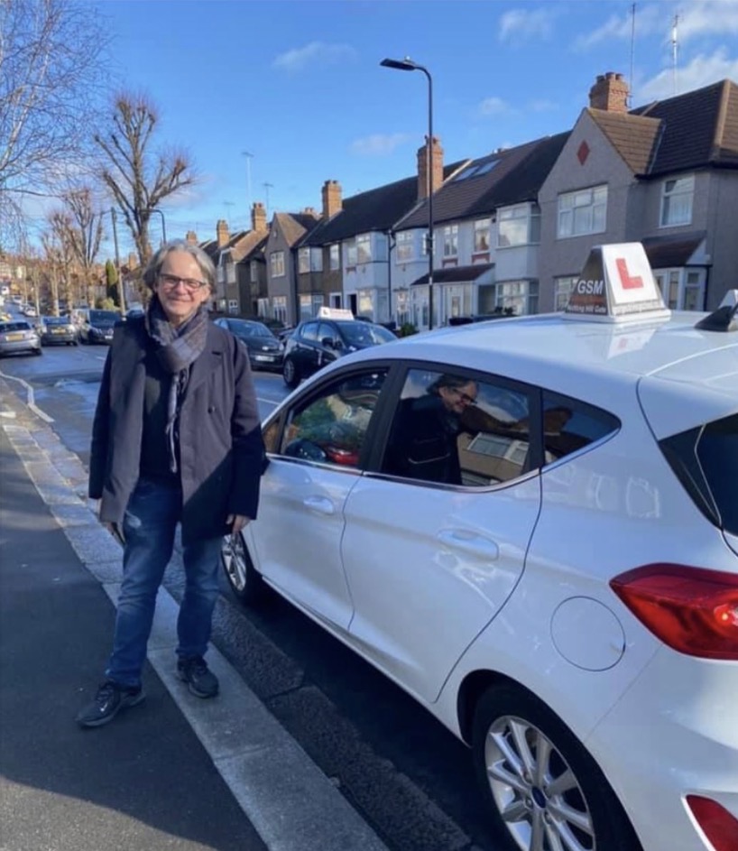 GSM founder standing beside the GSM Ford Fiesta on a leafy West London street